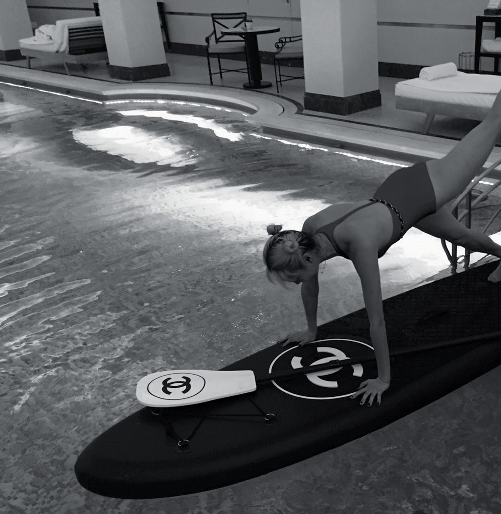 Model Soojoo Park kicked back at the hotel’s
iconic Art Deco pool by going paddle
boarding – Chanel style.